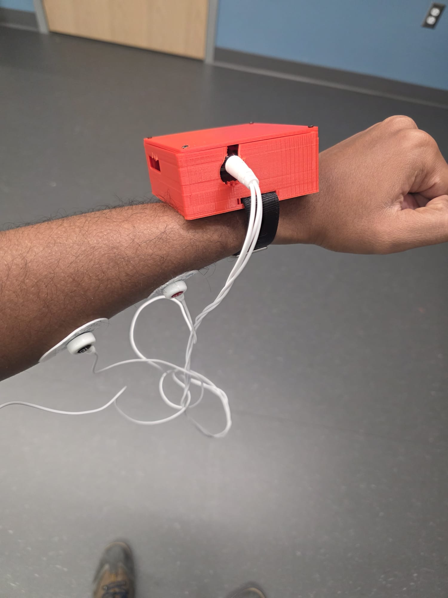 HeatMind wearable prototype secured to a forearm with electrode leads